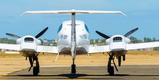 Image of small jet on runway from behind
