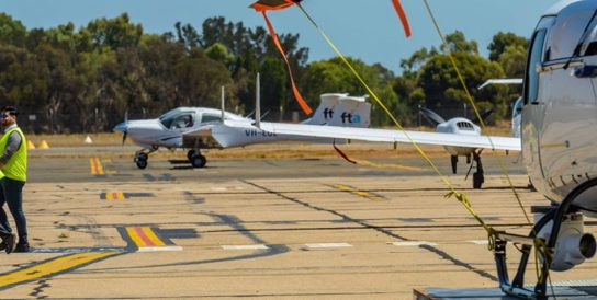 Photo of two employees and a jet on Parafield runway