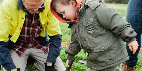 Photo of man and toddler gardening