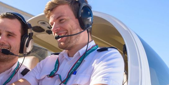 Image of two pilots in a small private jet