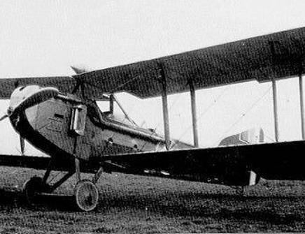 Historical black and white photo of a small plane