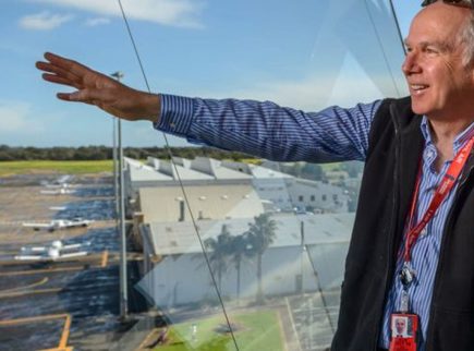 People at Parafield airport looking over the runway