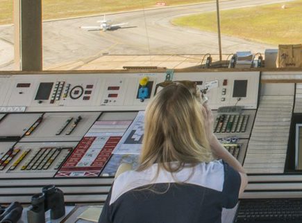 Image of people in Parafield Airport control tower looking out across the runway