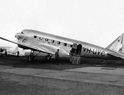 black and white photo of plane on a runway